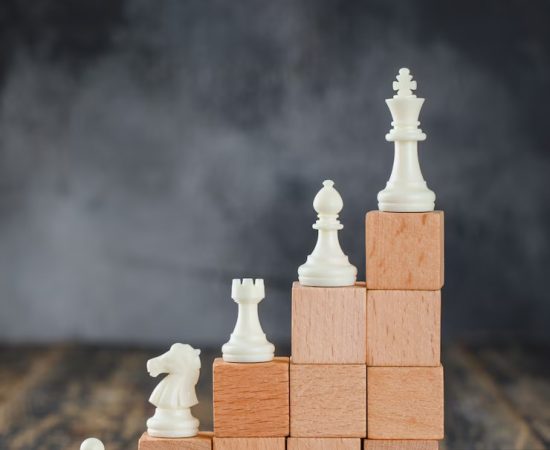 business-hierarchy-concept-with-chessboard-figures-pyramid-wooden-blocks-foggy-wooden-table-side-view_176474-9253